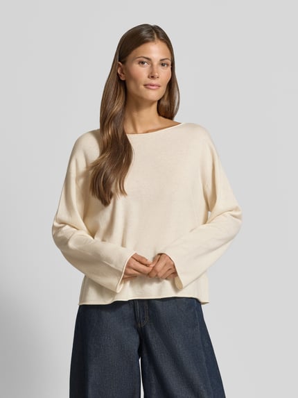 Frauenmodel trägt Regular Fit Pullover aus Kaschmir-Schurwoll-Mix Modell 'C_Faprosa' von BOSS für Damen, cremeweiß, weiche Textur, Kontrast zu dunkler Jeans, Damen Pullover von BOSS Orange, Nahaufnahme Oberkörper.