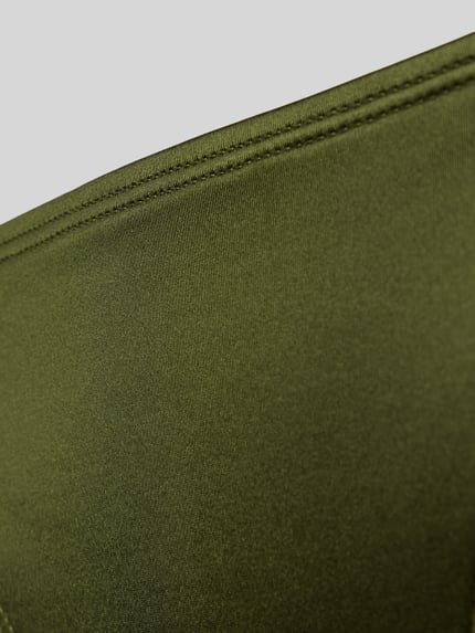 Productfoto, uniek effen ontwerp in olijfgroen, gladde textuur met sierdetails, Bikini-Slip met Zierelementen Modell 'GUARANA' van DORINA, materiaal-mix met stretch.