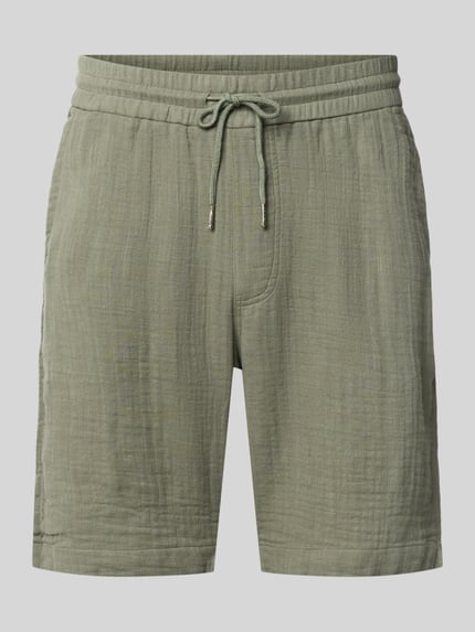 Produktfoto, Shorts mit Eingrifftaschen und elastischem Bund von Lindbergh aus Reine Baumwolle in Loose-Fit mit Kordelzug, grüne Farbe, sichtbare Struktur, französische Eingrifftaschen, Gesäßleistentaschen, Bundweite 43 cm, Innenbeinlänge 22 cm bei Größe M.