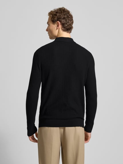 Męski model nosi Oversized Poloshirt aus reiner Baumwolle Modell 'CRAN' od SELECTED HOMME, czarny, gładki, z długim rękawem, widok z tyłu.