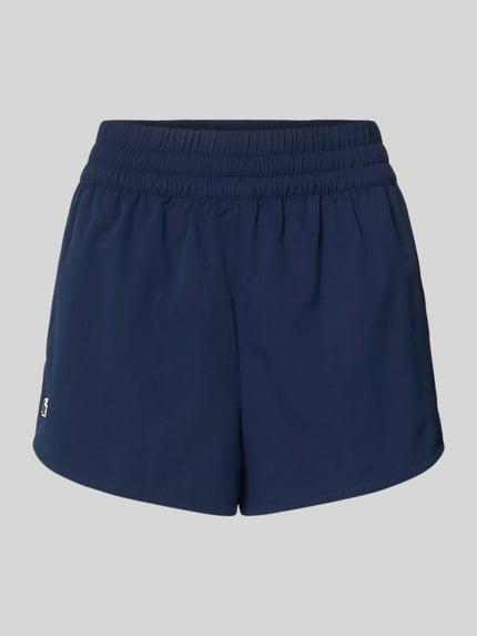 Productfoto, Regular Fit Sport-Shorts met logo-applicatie van Lacoste Sport, effen donkerblauw, piqué stretchmateriaal, elastische taille, sleutelritszak en telefoonzak, zonder sluiting.