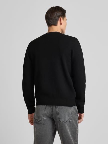 Männermodel draagt Regular Fit Gebreide pullover met schurwol van HUGO, look: effen, labelpatch, ronde hals, lange mouw, rompzoom geribd, knitwear. Ganzkörperansicht Rückansicht.
