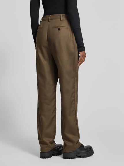 Frauenmodel trägt Straight Fit Chino mit Kellerfalten von black palms in Braun, strukturierter Stoff, Eingrifftaschen, Ganzkörperansicht Rückansicht.