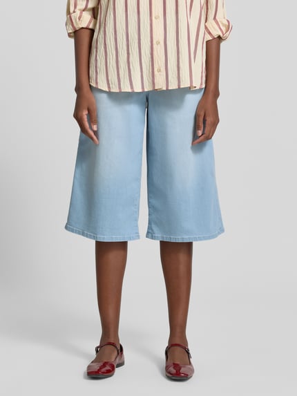 Frauenmodel trägt Bermudas im 5-Pocket-Design Modell 'Liv' von Angels in hellem Blau, Wide Leg Fit, Baumwoll-Mix, Nahaufnahme Oberschenkel bis Knie.