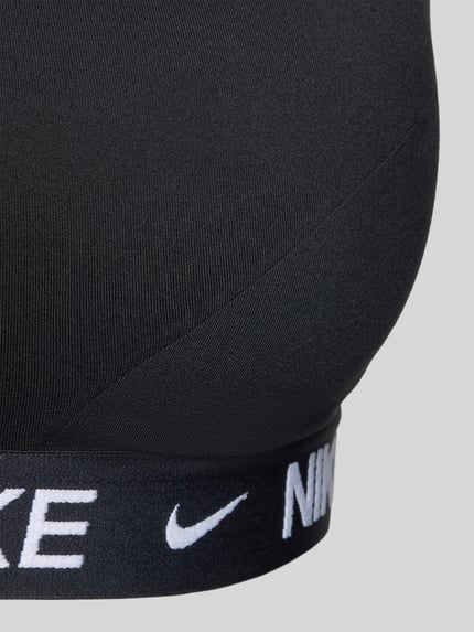 Productfoto, bustier met labeldetails en verstelbare bandjes van NIKE TRAINING in zwart, nauwsluitend, materiaalmix met stretch, haakjessluiting.