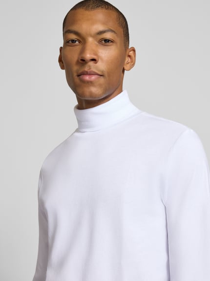 Männermodel trägt Regular Fit Longsleeve aus reiner Baumwolle mit Rollkragen von Christian Berg Men in Weiß, glatte Textur, Nahaufnahme Oberkörper. Rückenlänge bei Größe M 70 cm, elastische Abschlüsse.