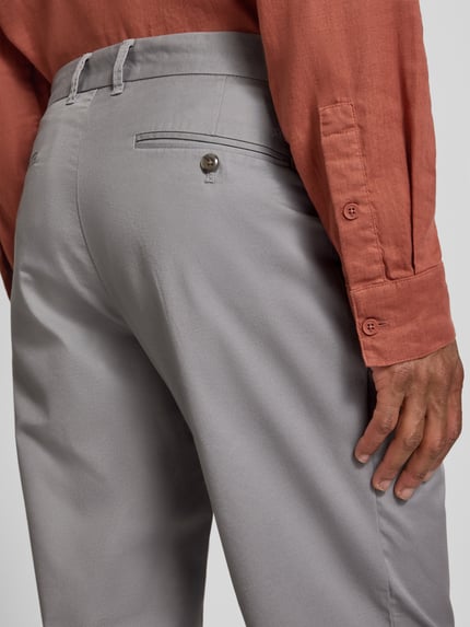 Männermodel trägt Tapered Fit Hose mit Gesäßtaschen van MCNEAL in lichtgrijs materiaalmix met katoen, detailaufnahme achterkant