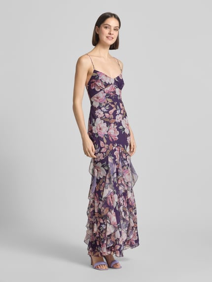 Frauenmodel trägt Slim Fit Abendkleid mit Rüschenbesatz von ADLYSH, floraler Allover-Print, Spaghettiträger, Schnürverschluss, Ganzkörperansicht von vorne.