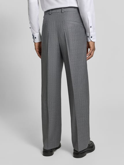 Männermodel trägt Regular Fit Bundfaltenhose aus Wolle von HUGO in Hellgrau mit Nadelstreifen und Gürtelschlaufen, Webware, Ganzkörperansicht Rückansicht.