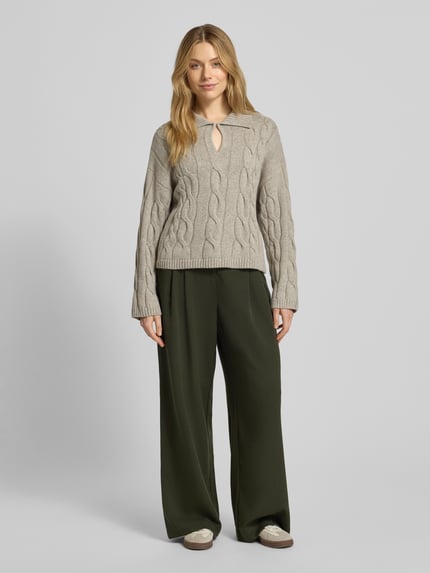 Vrouwenmodel draagt gebreide pullover met kabelpatroon Model 'Pavana Peony' van MSCH Copenhagen, materiaalmix met katoen, relaxed fit, platte kraag, druppelvormige hals, ruglengte 52 cm, mouwlengte 52 cm, voorkant volledig zicht.