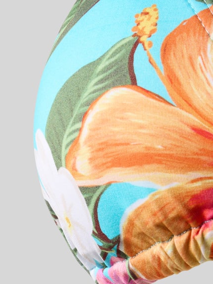 Produktfoto, Bikini-Oberteil im Allover-Look Modell 'CRICO MOOREA' von Banana Moon, florales Muster in Orange, Weiß und Grün auf türkisfarbenem Material-Mix mit Stretch-Anteil, feine Stofftextur.