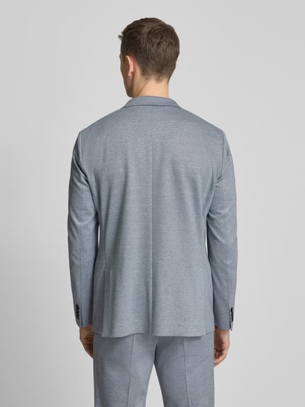 Männermodel trägt Extra Slim Fit Anzug in Unifarbenes-Design von Roy Robson im Viskose-Mix mit Stretch-Anteil, Ganzkörperansicht Rückansicht.
