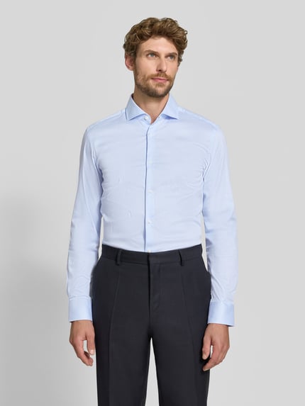 Männermodel trägt hellblaues Slim Fit Businesshemd aus Baumwoll-Mix Modell 'HANK' von BOSS, dezente Streifen, Ganzkörperansicht von vorne, Herren Businesshemd von BOSS.