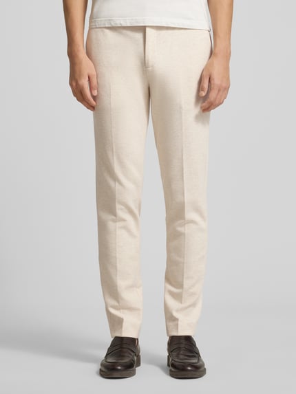Mannenmodel draagt stoffen broek met bandplooien, steekzakken en achterzakken van Scotch & Soda in katoenmix, recht model, helemaal vooraanzicht.
