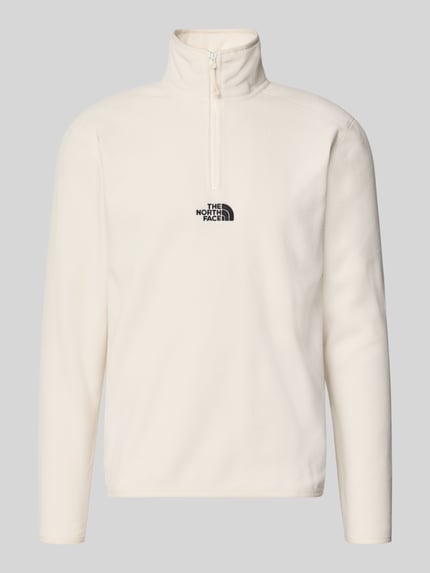 Produktfoto, Fleecepullover mit Label-Stitching von The North Face in Cremeweiß, Stehkragen, Reißverschluss, Regular Fit, weiche Textur