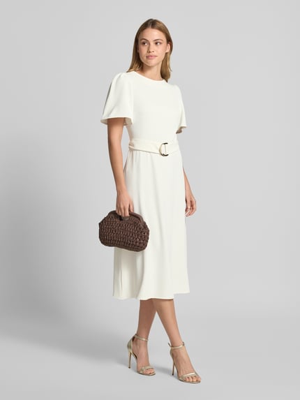 Frauenmodel trägt Cocktailkleid mit Gürtel und Rundhalsausschnitt von Rinascimento, Material-Mix mit Stretch-Anteil, Taillierter Schnitt, Midikleid, Rückseitiger Reißverschluss; cremefarbene Optik mit glattem Stoff, Ganzkörperansicht von vorne.
