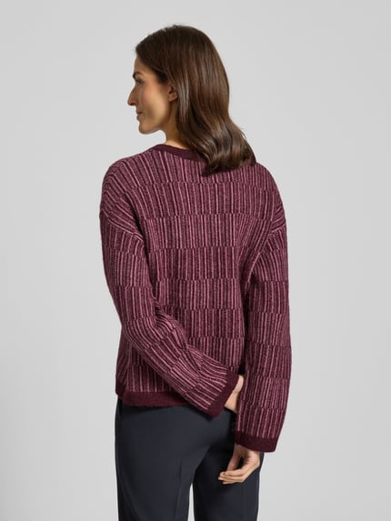 Vrouwenmodel draagt Relaxed Fit Pullover uit woll-mix met alpaca-aandeel Model 'FALVA' van Selected Femme, all-over structuurpatroon, gebreide look, ronde hals, lange mouwen, ribboorden, bordeaux en roze tinten. Ganzkörperansicht Rückansicht.