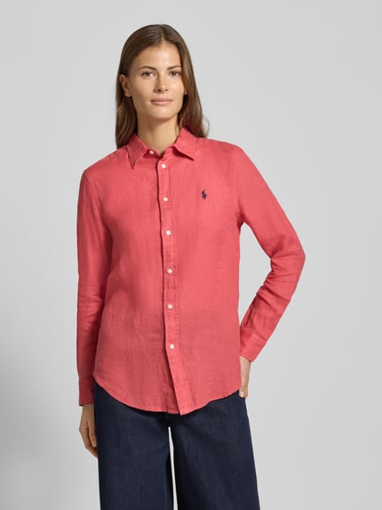 Vrouwenmodel draagt Overhemdblouse met knoopsluiting van Polo Ralph Lauren, zuiver linnen, los model, overhemdkraag, labelstitching, donkerroze, gladde textuur, ruglengte maat S 70 cm, mouwlengte 58 cm, vooraanzicht bovenlichaam.
