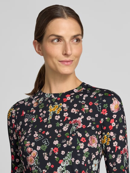 Vrouwenmodel draagt Longsleeve met Label-Print van Marc Cain, Materiaalmix met stretch, getailleerd model, ronde hals, ruglengte maat 36: 57 cm, Nahaufnahme bovenlichaam.