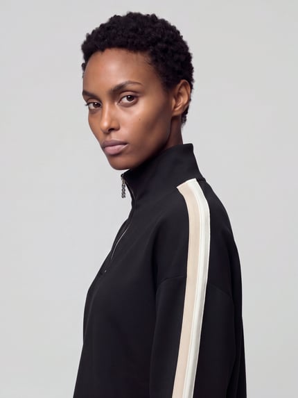 Frauenmodel trägt Pyjama-Oberteil mit Kontraststreifen von BOSS in Schwarz mit Struktur, Stehkragen, Jersey, Nahaufnahme Oberkörper.