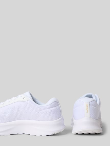 Productfoto, Low Top Sneaker uit mesh model 'NEO RUN ACE' van Lacoste, effen wit, afgeronde neus, platte zool, logo- en labeldetails, vetersluiting, gestructureerde zool, damesvariant