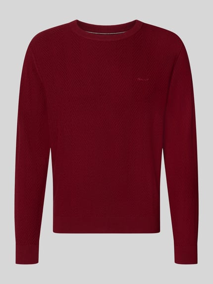 Produktfoto, Regular Fit Pullover aus Baumwoll-Woll-Mix von GANT in dunklem Rot mit feinem Strickmuster auf grauem Hintergrund.