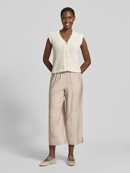 Vrouwenmodel draagt Regular Fit Culotte uit viscosemix van Tom Tailor, effen look, regular fit pasvorm, popeline materiaalverwerking, zij-steekzakken, tunnelkoord, elastische boord, all-over motief, kleur beige, complete lichaamsvoorzijde.