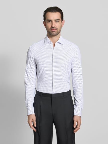 Männermodel trägt Slim Fit Businesshemd mit Kentkragen Modell 'KENNO' von HUGO, Optik: Allover-Muster, Ganzkörperansicht von vorne.