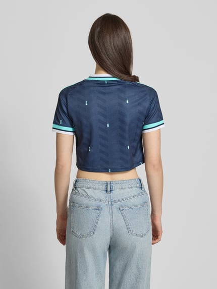 Frauenmodel trägt DFB Cropped Auswärtstrikot 2026 von adidas Sportswear, Mehrfarbig, Regular-Fit, Cropped, V-Ausschnitt, Applikation; Ganzkörperansicht Rückansicht.