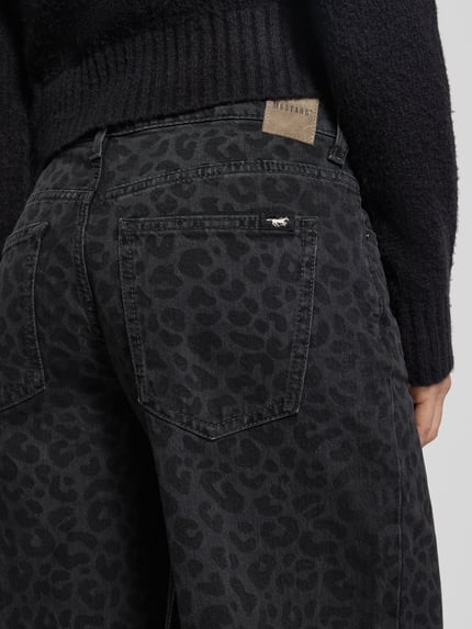 Frauenmodel trägt Wide Fit Jeans mit Allover-Animal-Print Modell 'Medley' von Mustang, dunkler Animal-Print, 5-Pocket, Nahaufnahme Rückansicht.