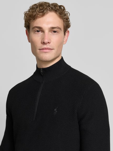 Mannenmodel draagt Regular Fit Troyer aus Baumwoll-Mix mit Logo-Stitching van Polo Ralph Lauren in zwarte tricotlook, gestikt logo, korte ritssluiting, katoenmix, nahaufnahme bovenlichaam.