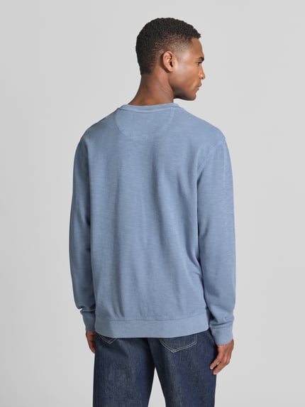 Männermodel trägt Regular Fit Sweatshirt mit Rundhalsausschnitt von Scotch & Soda aus Baumwoll-Mix, Label-Detail, Rückenansicht Ganzkörperansicht.