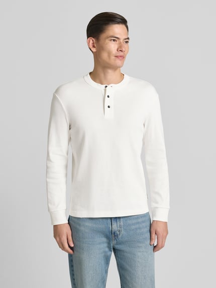 Männermodel trägt weißes Sweatshirt mit gerippten Abschlüssen von ARMANI EXCHANGE, reine Baumwolle, Regular Fit, Ganzkörperansicht von vorne.