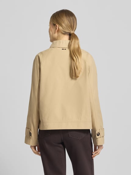 Kobiece modelka nosi Regular Fit Trenchcoat aus Baumwoll-Lyocell-Mix od s.Oliver RED LABEL, beżowy, twill, widok całej sylwetki od tyłu.