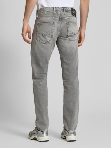 Männermodel trägt Regular FitJeans im 5-Pocket-Design Modell 'Grover' von Replay aus bawełna, prosty krój, szara faktura, Ganzkörperansicht Rückansicht.