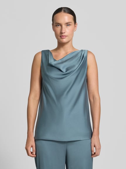 Frauenmodel trägt Regular Fit Bluse aus Satin von SWING in Blau mit Wasserfall-Ausschnitt, Falten-Optik, ärmellos, Ganzkörperansicht von vorne.