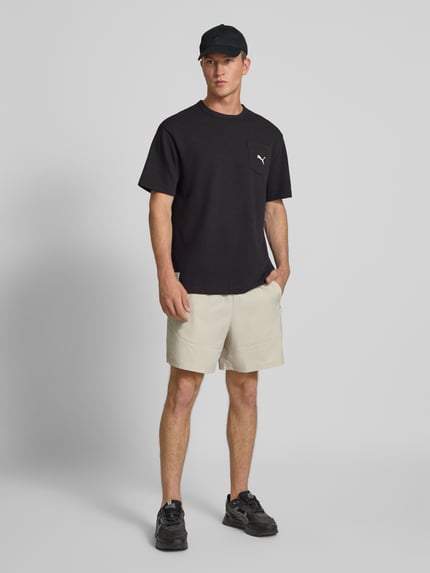 PUMA Performance Relaxed Fit T-Shirt mit Brusttasche Black 1