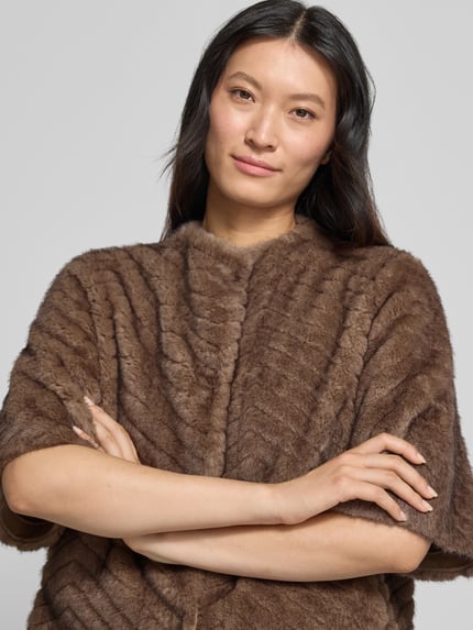 Frauenmodel trägt Regular Fit Jacke aus Kunstfell von White Label in Braun mit 1/2-Arm und Rundhalsausschnitt, Nahaufnahme Oberkörper. Rückenlänge, Schulterbreite und Brustweite laut Größe 36, weiche Kunstfell-Textur und dezente Musterung.