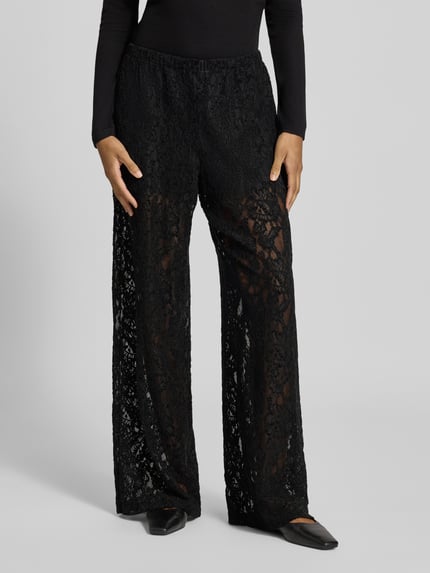 Frauenmodel trägt schwarze Wide Leg Hose aus Spitze Modell 'COCO' von Topshop, Material-Mix mit Stretch, ganzkörperansicht von vorne.