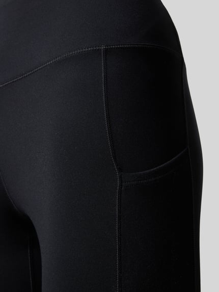 Produktfoto, schwarze Slim Fit Leggins mit Logo-Print von NIKE TRAINING aus elastischem Material-Mix und breitem Bund, glatte Textur