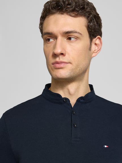 Männermodel trägt Regular Fit Poloshirt mit opstaande kraag van HECHTER PARIS van puur katoen, knoopsluiting, labelstitching, ruglengte maat M 67 cm, Nahaufnahme Oberkörper.