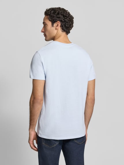 Männermodel trägt T-Shirt mit Logo und Rundhalsausschnitt Modell 'YKOBOW' von American Vintage in Hellblau, reine Baumwolle, Ganzkörperansicht Rückansicht, Regular Fit, Rückenlänge bei Größe M 70 cm.