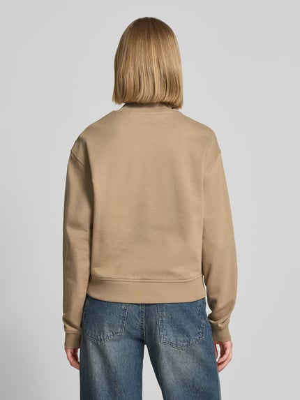 Frauenmodel trägt Regular Fit Sweatshirt aus reiner Baumwolle Modell 'DAXANDRIA' von HUGO, Optik: Unifarben, Logo-Stitching, Rundhals, Langarm, Material: Reine Baumwolle, Ganzkörperansicht Rückansicht.