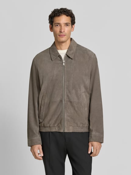 Männermodel trägt Regular Fit Lederjacke aus echtem Ziegenleder von Marc O'Polo in Grau, glatte Textur, Ganzkörperansicht von vorne. Herren Leder- / Kunstlederjacke von Marc O'Polo.