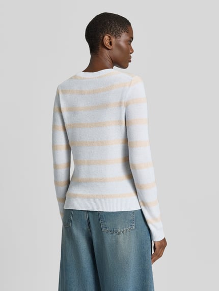 Frauenmodel trägt Strickpullover aus Kaschmir-Mix von Christian Berg Woman, gestreift in Beige-Weiß, tailliert, Ganzkörperansicht Rückansicht.