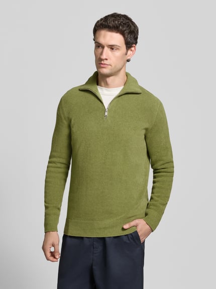 Männermodel trägt Pullover mit Troyerkragen von MARC O'POLO in grün, Feinstrick mit Struktur, Reißverschluss, Regular Fit, Ganzkörperansicht von vorne.