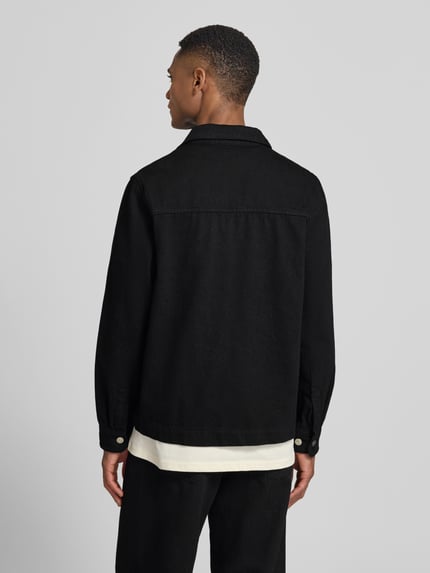 Männermodel trägt Regular Fit Overshirt mit Brusttasche Modell 'Layton' von Les Deux, Reine Baumwolle, schwarze Farbe, Ganzkörperansicht Rückansicht.