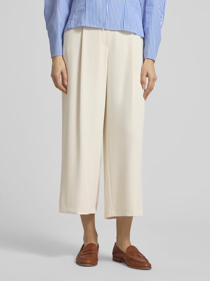 Frauenmodel trägt Stoffhose mit elastischem Bund von Jake*s Collection, weites Bein, beige Farbe, Material-Mix, Nahaufnahme Unterkörper.