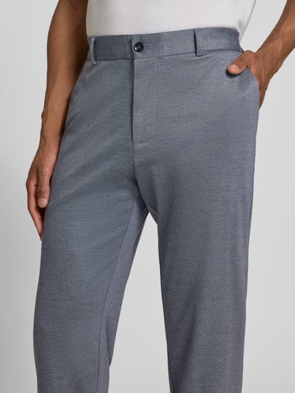 Männermodel trägt Slim Fit Anzughose aus Viskose-Mix Modell 'TIUS2' von Strellson in melangelook met steekzakken, nahaufnahme onderlichaam.