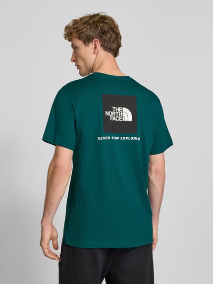 Männermodel trägt donkergroen t-shirt van katoenmix met labelprint Model 'Evolution' van The North Face, regular fit, ruglengte bij maat M 73 cm, rugaanzicht